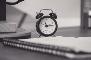 Alarm clock and notebook to begin writing your brain dump